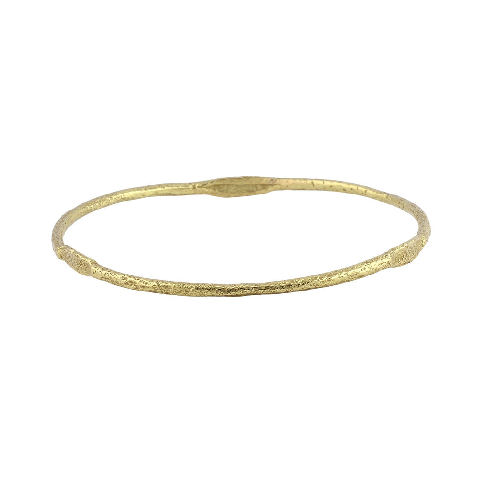 Angled view of Bhangra Bangle in 18k yellow gold by Betsy Barron