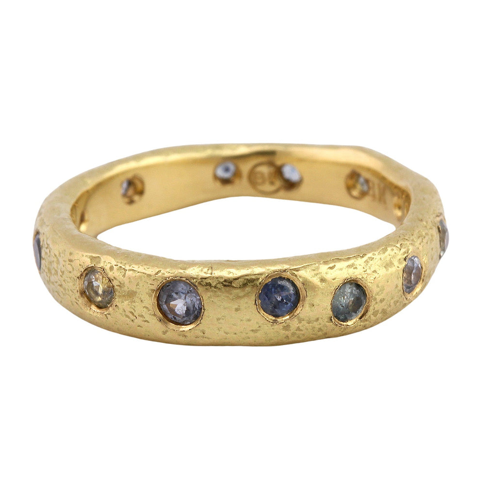 
                      
                        Angled view of Narrow Molten Band in 18k yellow gold with Montana sapphires by Betsy Barron
                      
                    