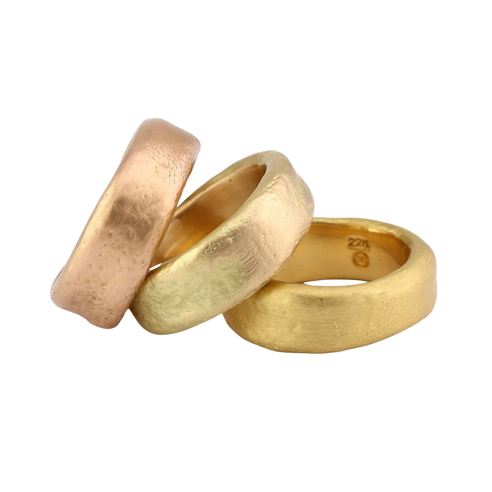 
                      
                        Three stacked Perry bands by Betsy Barron Jewellery in 18k Rose and 18k and 22k Yellow Gold.
                      
                    