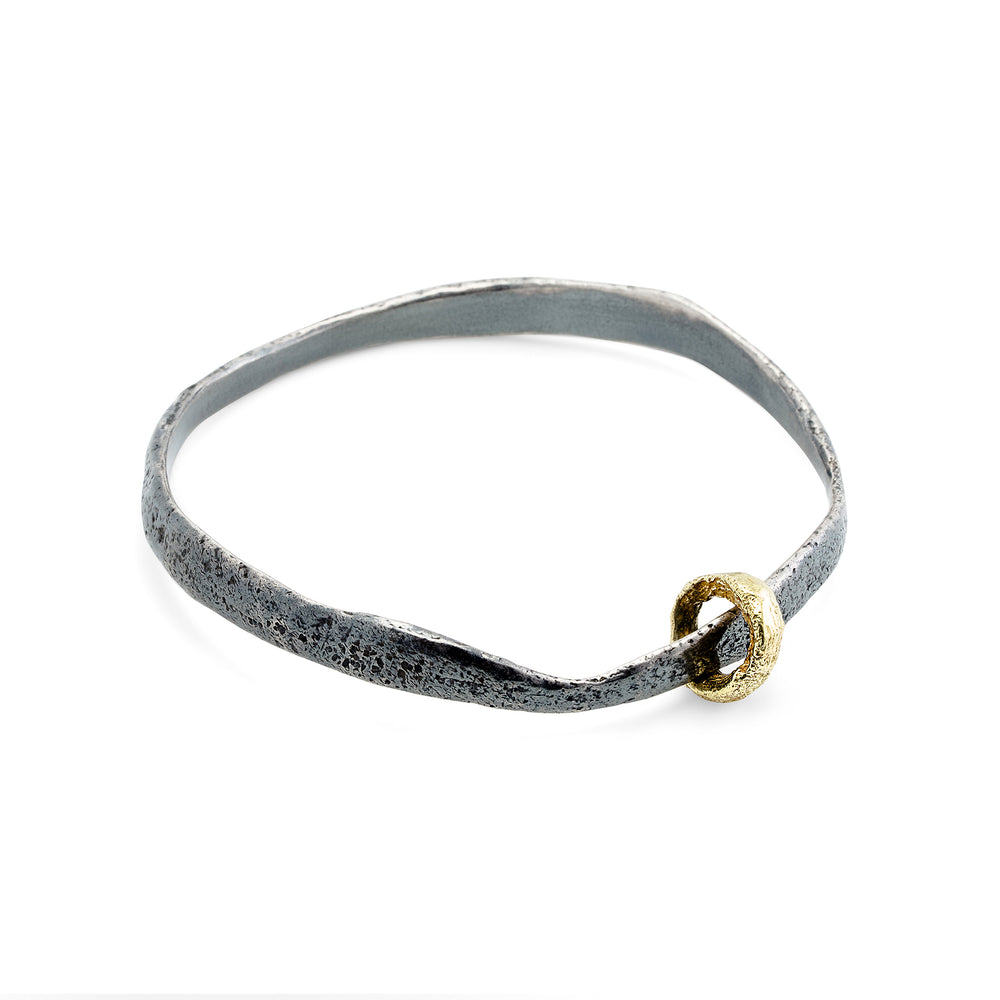 
                      
                        Molten Bangle in oxidized sterling silver w/ 18k yellow gold ring
                      
                    