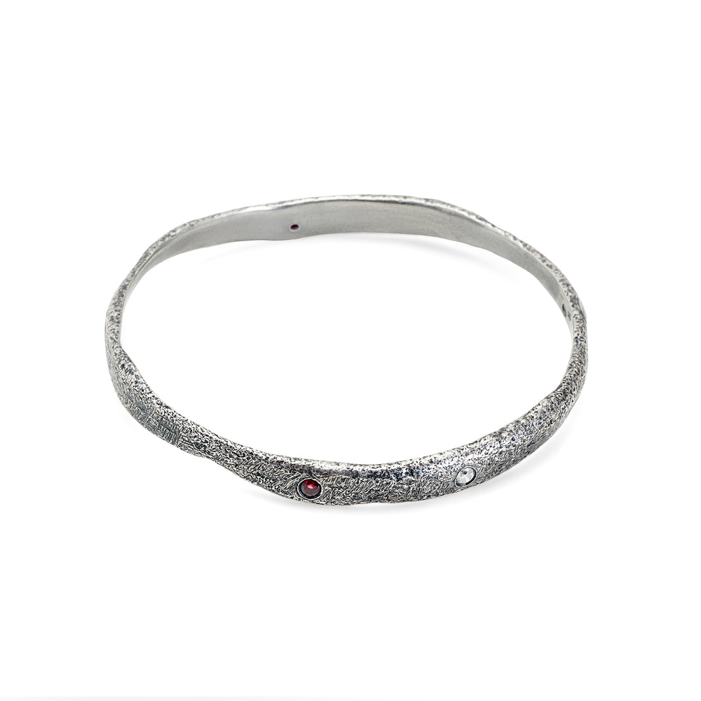 
                      
                        Molten Bangle in oxidized sterling silver with gemstones
                      
                    