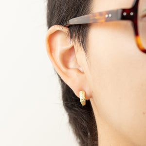 Model wearing Small Molten Hoop earring in right ear