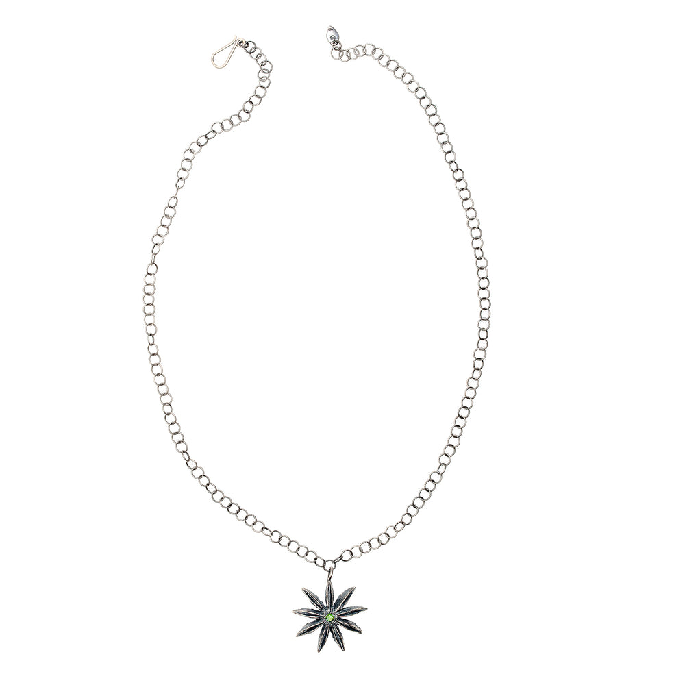 
                      
                        Top-down view of sterling silver Star Anise Necklace with emerald
                      
                    